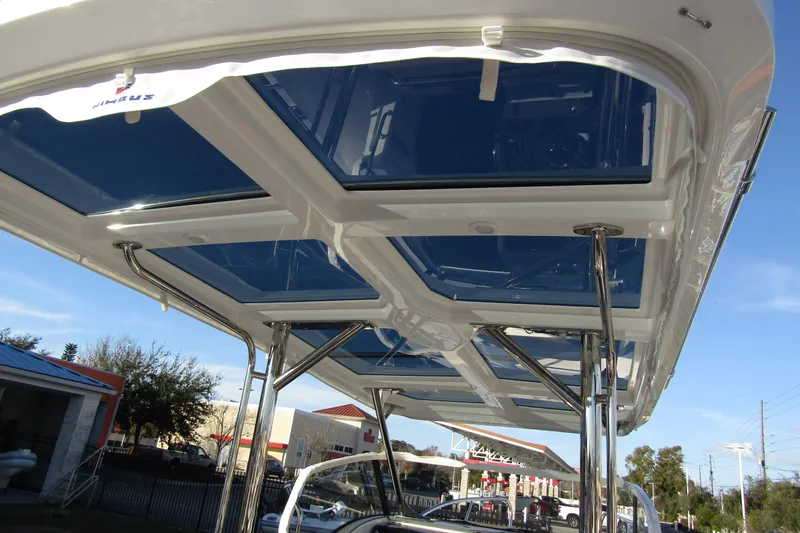  Yacht Photos Pics 2025 Nimbus Tender 9 boat with sleek glass roof and metal supports.