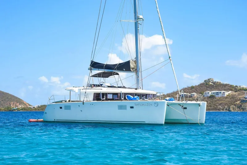 Rapscallion Yacht Photos Pics 2018 Lagoon 450 F catamaran sailing on clear blue waters under a sunny sky.