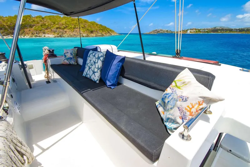 Rapscallion Yacht Photos Pics Luxurious Lagoon 450 F yacht deck with cushions, overlooking turquoise waters and scenic islands.