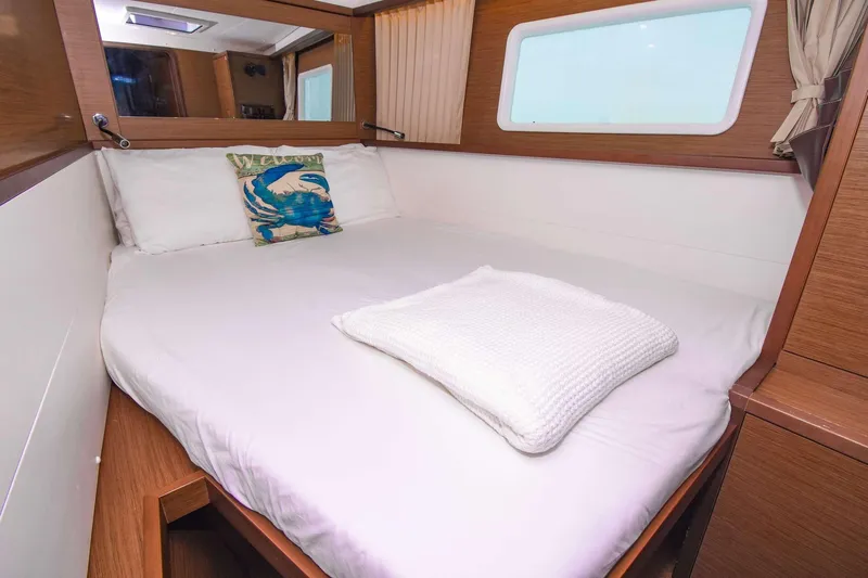 Rapscallion Yacht Photos Pics Cozy cabin interior of 2018 Lagoon 450 F yacht with comfortable bed and nautical decor.