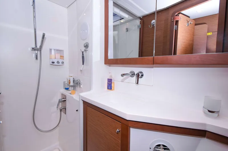 Rapscallion Yacht Photos Pics Luxurious bathroom in 2018 Lagoon 450 F yacht with modern fixtures and wooden accents.