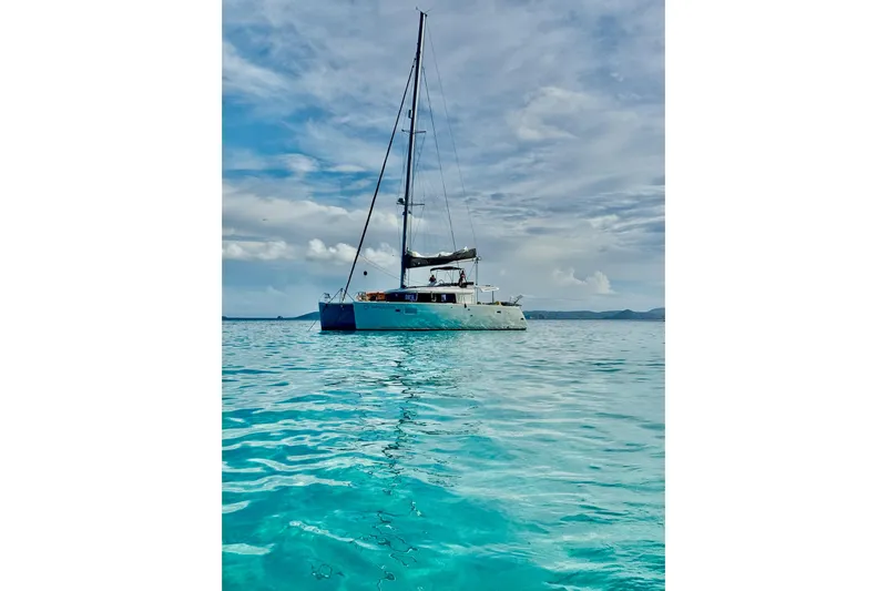 Rapscallion Yacht Photos Pics 2018 Lagoon 450 F catamaran sailing on clear turquoise waters.