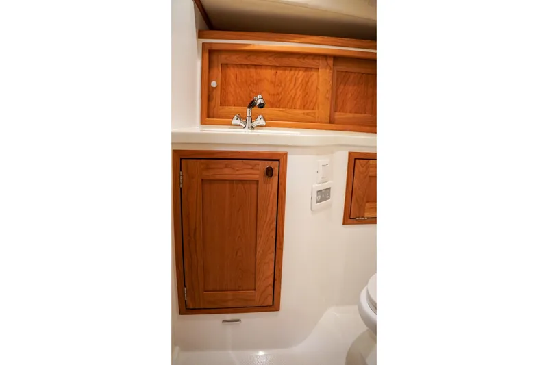 In Stock Yacht Photos Pics 2025 MJM 35 yacht bathroom with wooden cabinets and modern fixtures.