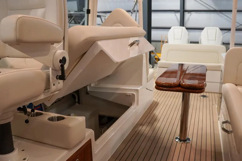 In Stock Yacht Photos Pics Luxurious interior of 2025 MJM 35 boat with elegant seating and wooden table.