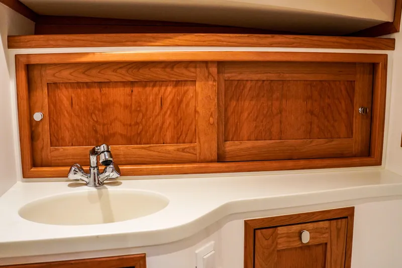 In Stock Yacht Photos Pics 2025 MJM 35 yacht interior with wooden cabinetry and modern sink design.