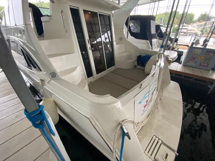  Yacht Photos Pics 2006 Carver 36 Mariner yacht docked, featuring spacious deck and sliding glass doors.