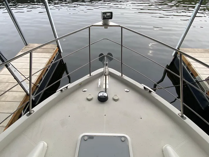  Yacht Photos Pics 2006 Carver 36 Mariner boat bow view at dock, featuring railing and calm water.