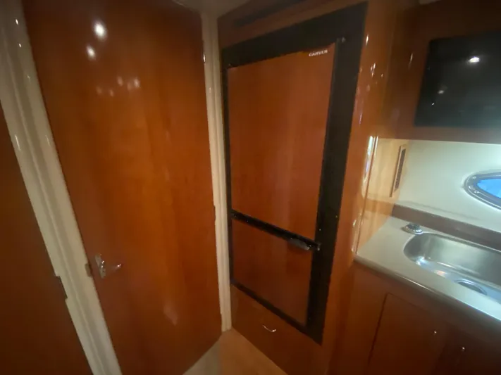  Yacht Photos Pics Interior of 2006 Carver 36 Mariner yacht with wood cabinetry and compact kitchen area.