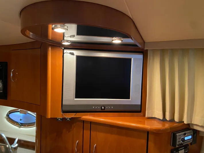  Yacht Photos Pics 2006 Carver 36 Mariner interior with TV and wood cabinetry.