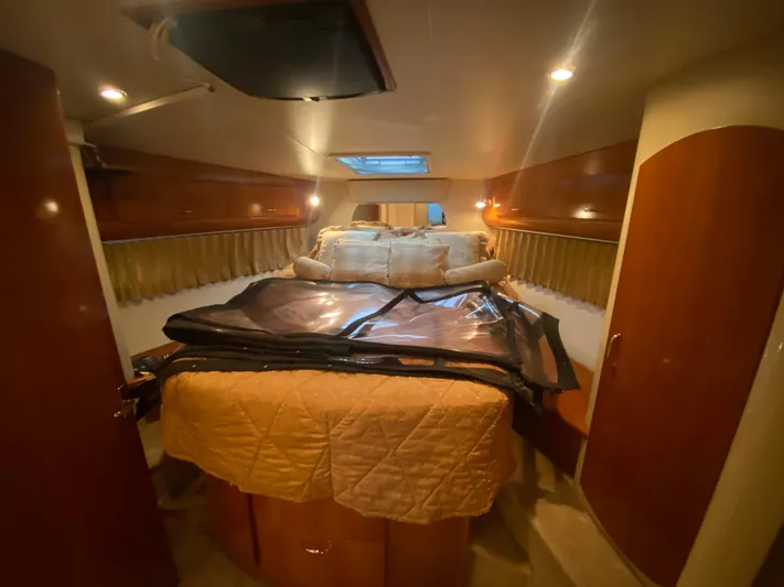  Yacht Photos Pics Interior cabin of 2006 Carver 36 Mariner yacht with cozy bedding and warm lighting.