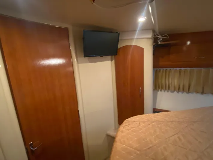  Yacht Photos Pics Interior of 2006 Carver 36 Mariner with wood doors, TV, and bed.