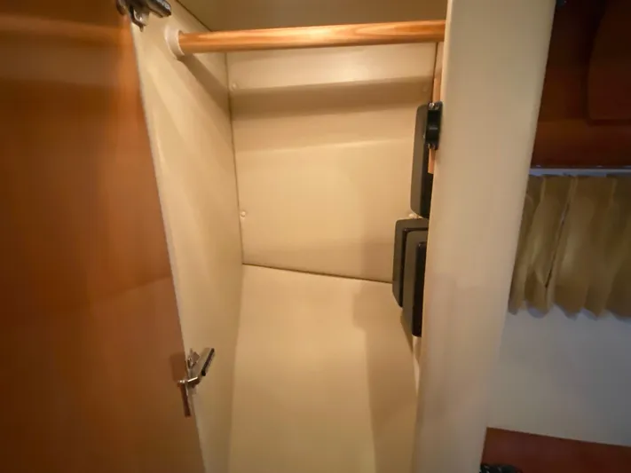  Yacht Photos Pics Empty closet inside 2006 Carver 36 Mariner yacht, featuring wooden rod and secure lock.