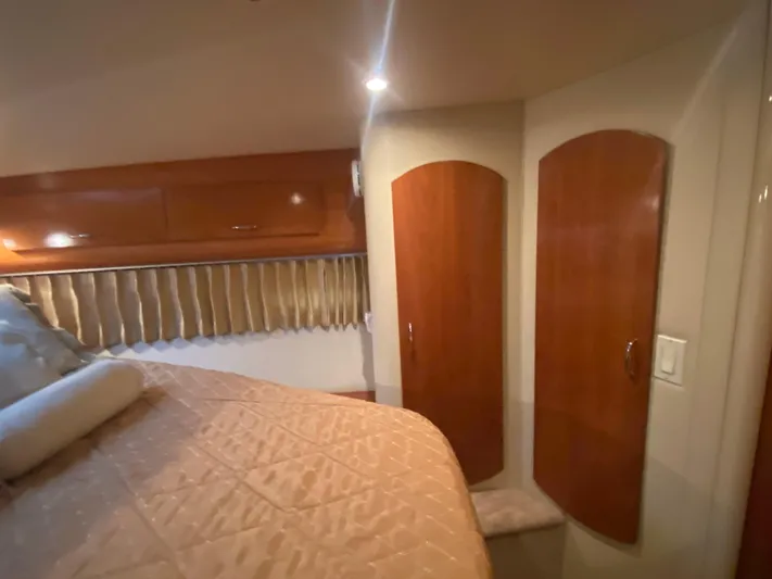  Yacht Photos Pics Interior of 2006 Carver 36 Mariner with wood cabinets and cozy bedding.