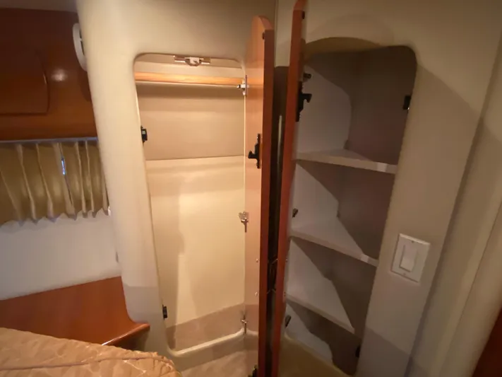  Yacht Photos Pics 2006 Carver 36 Mariner interior closet with open shelving and hanging space.
