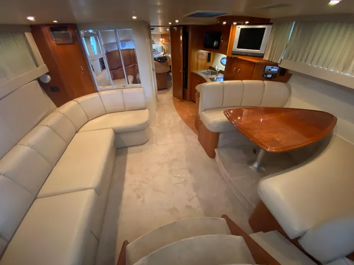  Yacht Photos Pics Luxurious interior of 2006 Carver 36 Mariner yacht with plush seating and wooden accents.