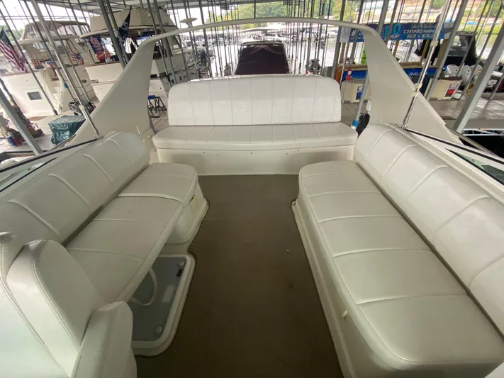  Yacht Photos Pics 2006 Carver 36 Mariner interior with white leather seating in a marina setting.