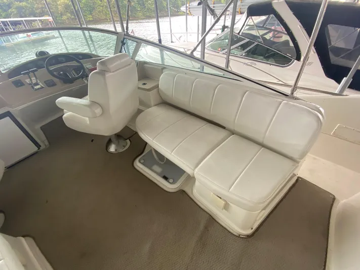  Yacht Photos Pics 2006 Carver 36 Mariner interior with white seating and helm, docked by the water.