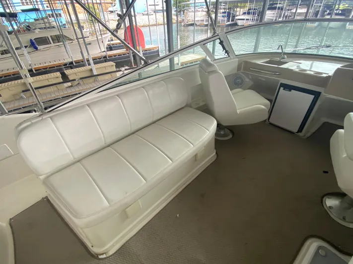  Yacht Photos Pics Interior of 2006 Carver 36 Mariner yacht with white seating and helm.