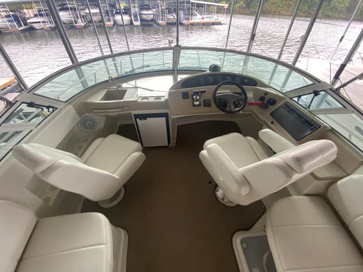  Yacht Photos Pics Interior view of 2006 Carver 36 Mariner yacht cockpit with white seating and control panel.