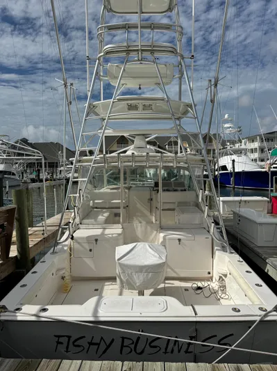 Fishy Business Yacht Photos Pics 2005 Cabo 35 Express boat docked, featuring a spacious deck and fishing tower.