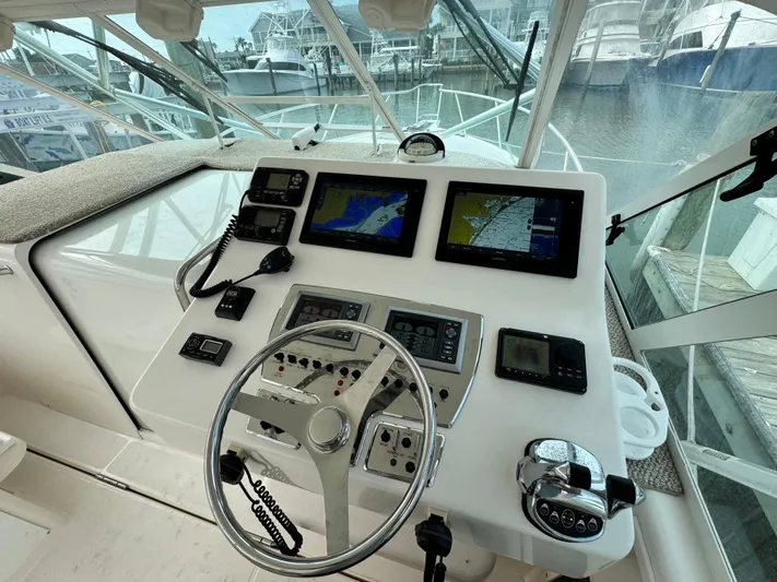 Fishy Business Yacht Photos Pics Helm of 2005 Cabo 35 Express with navigation screens and controls.