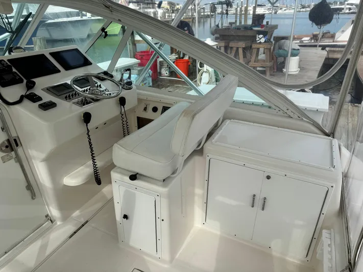 Fishy Business Yacht Photos Pics 2005 Cabo 35 Express boat cockpit with steering wheel and control panel.