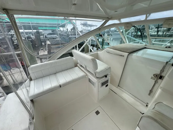 Fishy Business Yacht Photos Pics 2005 Cabo 35 Express boat interior with white seating and marina view.