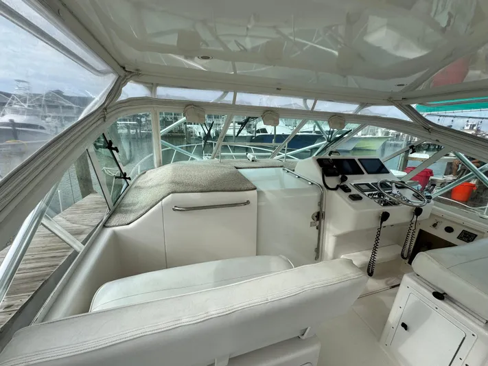 Fishy Business Yacht Photos Pics 2005 Cabo 35 Express boat interior with helm, steering wheel, and navigation equipment.