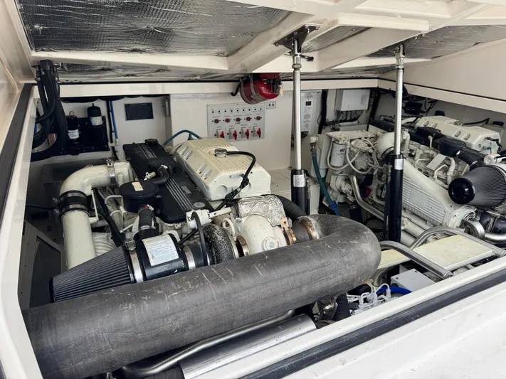 Fishy Business Yacht Photos Pics Engine room of a 2005 Cabo 35 Express boat, showcasing dual engines and mechanical components.