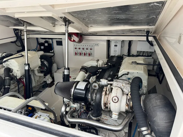 Fishy Business Yacht Photos Pics Engine room of a 2005 Cabo 35 Express boat, showcasing dual engines and mechanical components.