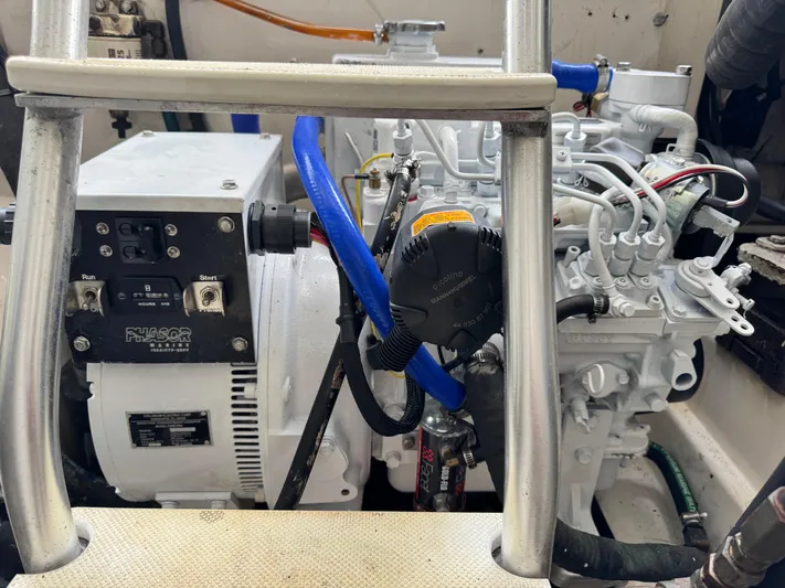 Fishy Business Yacht Photos Pics Engine compartment of a 2005 Cabo 35 Express boat, featuring a Phasor generator.