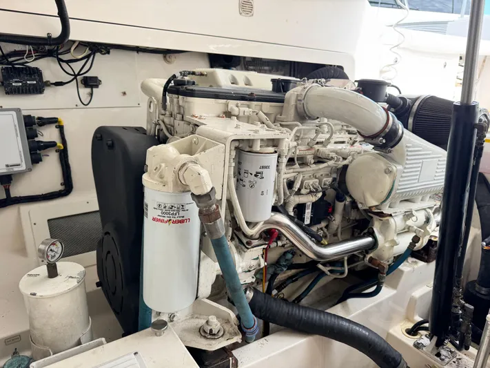 Fishy Business Yacht Photos Pics Engine compartment of a 2005 Cabo 35 Express boat, showcasing detailed mechanical components.