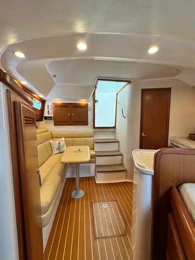 Fishy Business Yacht Photos Pics Interior of 2005 Cabo 35 Express yacht with cozy seating and wooden flooring.