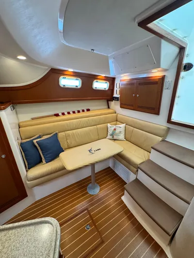 Fishy Business Yacht Photos Pics Interior of 2005 Cabo 35 Express yacht with cozy seating and wooden flooring.