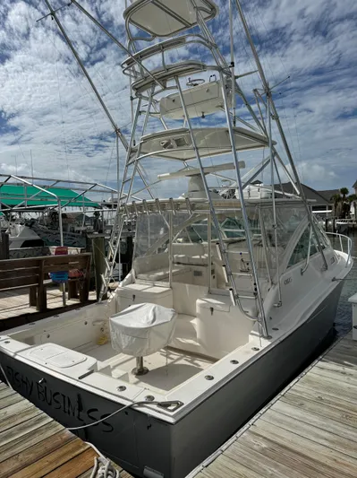 Fishy Business Yacht Photos Pics 2005 Cabo 35 Express boat docked, featuring a tall tower and spacious deck.