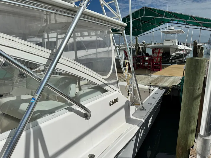 Fishy Business Yacht Photos Pics 2005 Cabo 35 Express boat docked at marina under blue sky.