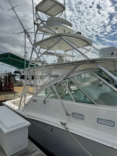 Fishy Business Yacht Photos Pics 2005 Cabo 35 Express boat docked under cloudy sky.