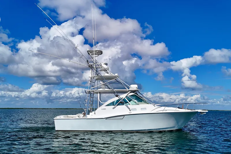 Fishy Business Yacht Photos Pics 2005 Cabo 35 Express boat on calm ocean under blue sky with clouds.