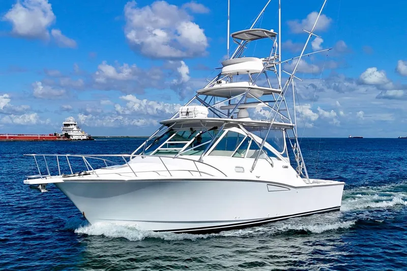 Fishy Business Yacht Photos Pics 2005 Cabo 35 Express yacht cruising on open water under a clear blue sky.