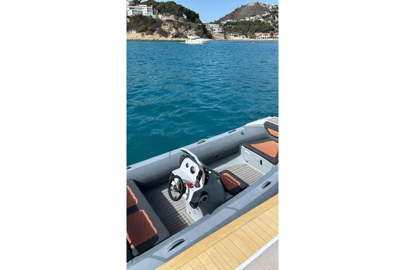 4ever Yacht Photos Pics 2022 Lagoon 67 boat interior with steering wheel, docked by scenic coastline.