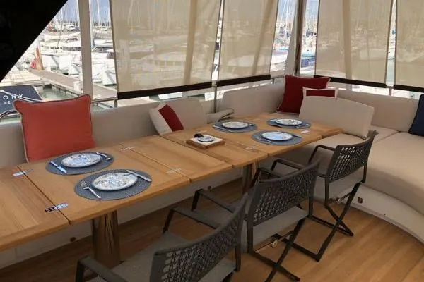 4ever Yacht Photos Pics Luxurious dining area on 2022 Lagoon 67 yacht with elegant table setting.