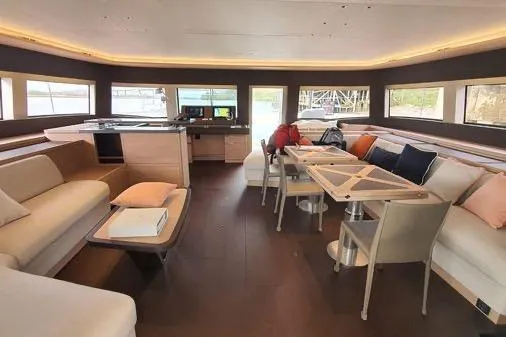 4ever Yacht Photos Pics Luxurious interior of 2022 Lagoon 67 yacht with modern seating and dining area.