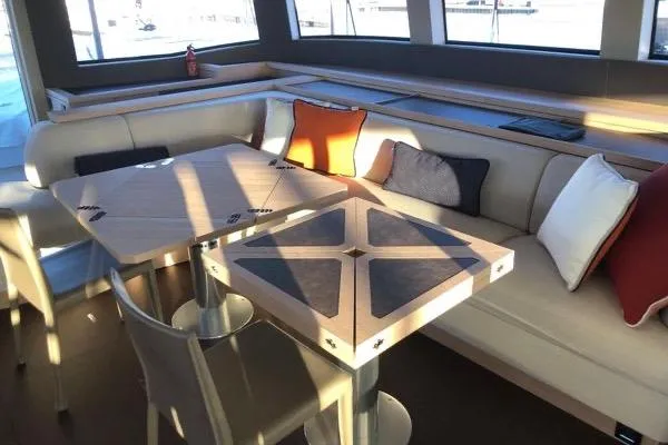 4ever Yacht Photos Pics Luxurious interior of 2022 Lagoon 67 yacht with modern seating and stylish cushions.