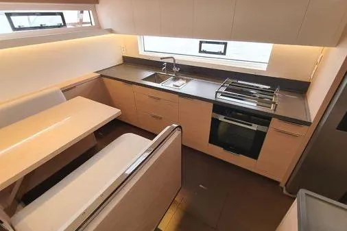 4ever Yacht Photos Pics Modern kitchen interior of 2022 Lagoon 67 yacht with sleek design and appliances.