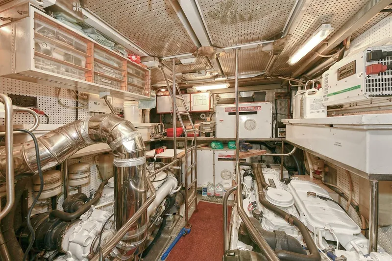 Symmetry Yacht Photos Pics Engine room of 2002 Grand Alaskan Flushdeck yacht, featuring machinery and storage.