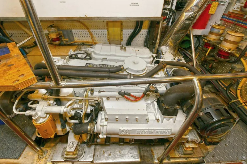 Symmetry Yacht Photos Pics Engine room of 2002 Grand Alaskan Flushdeck yacht featuring a Caterpillar marine engine.