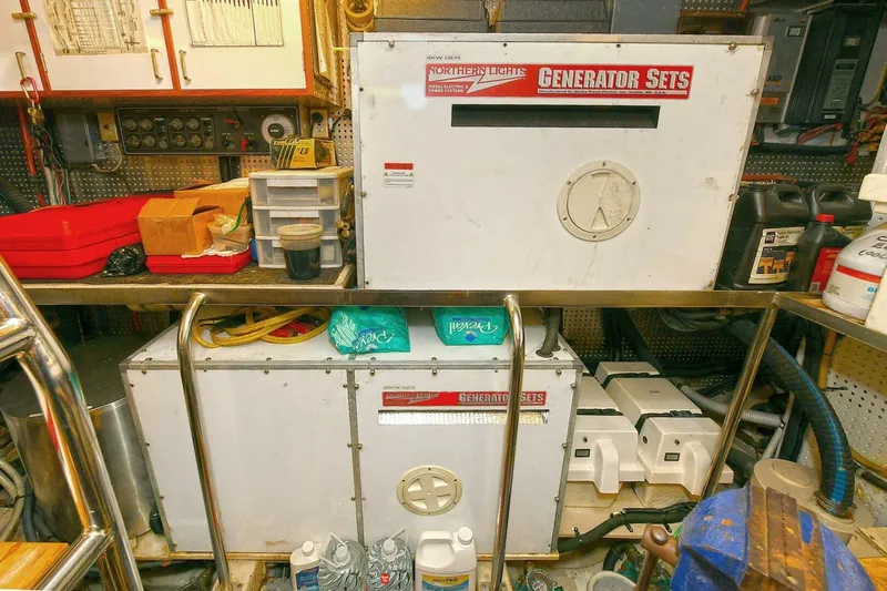 Symmetry Yacht Photos Pics Engine room of 2002 Grand Alaskan Flushdeck with generator sets and equipment.