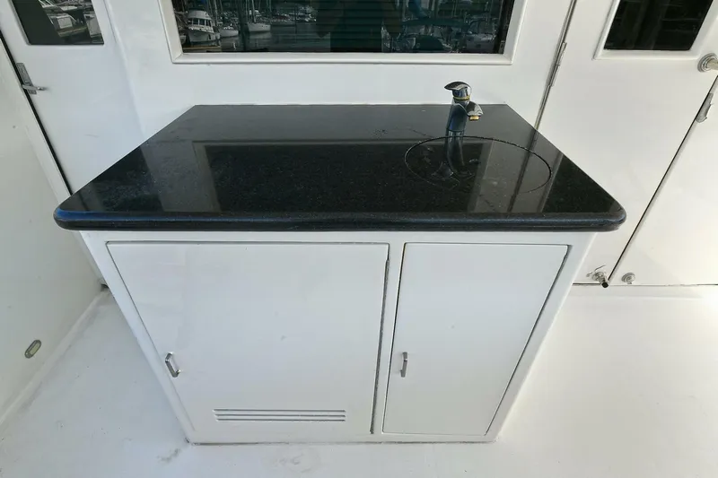 Symmetry Yacht Photos Pics Outdoor sink with black countertop on 2002 Grand Alaskan Flushdeck yacht.