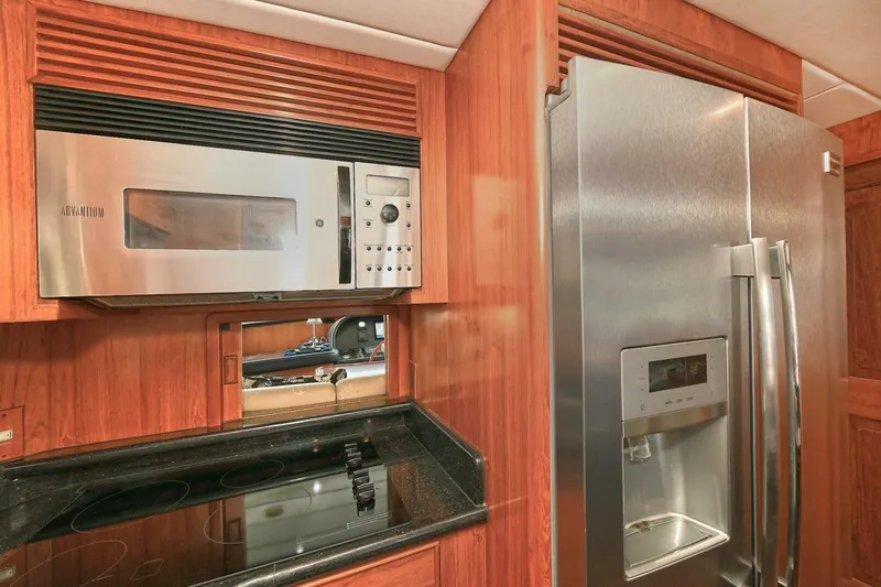 Symmetry Yacht Photos Pics Luxury kitchen in 2002 Grand Alaskan Flushdeck yacht with stainless steel appliances.