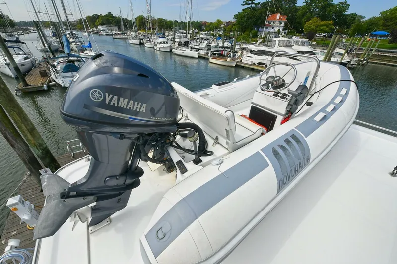 Symmetry Yacht Photos Pics Inflatable boat with Yamaha motor on 2002 Grand Alaskan Flushdeck yacht, docked at marina.
